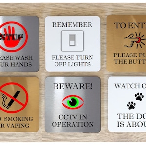 May include: Set of six square metal signs with various safety and warning messages. The signs are in different colours, including silver, gold, and white. The signs feature icons and text, such as "Stop", "Please Wash Your Hands", "Remember", "Please Turn Off Lights", "To Enter", "Please Push The Button", "Beware", "CCTV In Operation", "Watch Out", "The Dog Is About", "No Smoking Or Vaping".