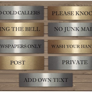 May include: A set of eight metallic signs with brushed silver and gold finishes. The signs have black text and include phrases like "No Cold Callers", "Please Knock", "Ring the Bell", "No Junk Mail", "Newspapers Only", "Wash Your Hands", "Post", and "Private". There is also a blank sign that says "Add Own Text".