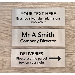 May include: Three brushed silver aluminium signs with black text. The top sign says "YOUR TEXT HERE Brushed silver aluminium signs 15x5cm/6x2". The middle sign says "Mr A Smith Company Director". The bottom sign says "DELIVERIES Please use the parcel box on your right" with a black arrow pointing to the right.