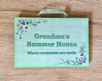 May include: A green wooden sign with the text "Grandma's Summer House Where memories are made" and floral vines with butterflies.
