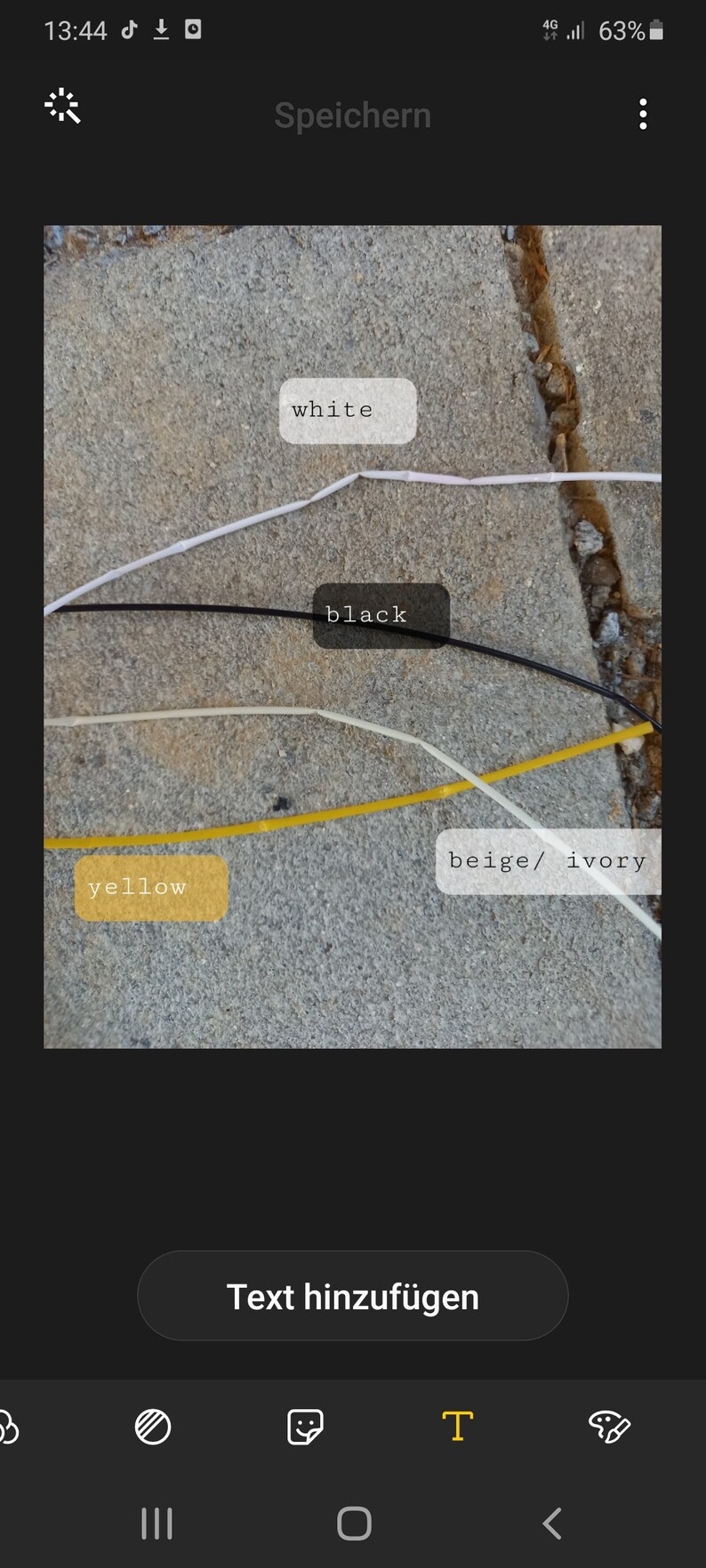 May include: Image showing thin, colored cords labeled with the colors white, black, yellow, and beige/ivory. The cords are laid out on a textured, gray surface. The word "white" is in a white rectangle.