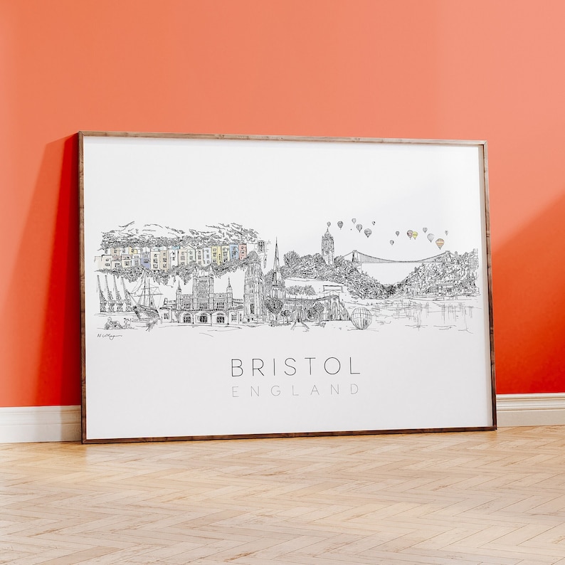 May include: Black and white line drawing of the Bristol skyline, including the Clifton Suspension Bridge, hot air balloons, and the text "BRISTOL ENGLAND".