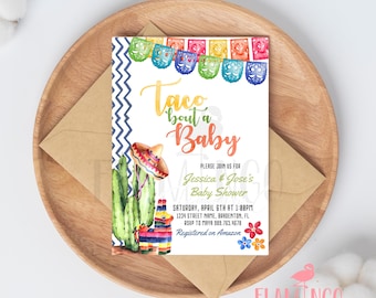 May include: A white baby shower invitation with a colorful taco and cactus illustration. The text reads "Taco bout a Baby" and includes details for the event, including the date, time, location, and RSVP information. The invitation also mentions that the couple is registered on Amazon.