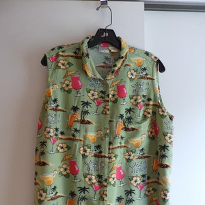 May include: A sleeveless green button-down shirt with a tropical print featuring cocktails, palm trees, and the text "Life's a Beach!"