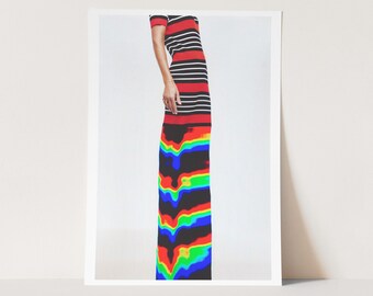 May include: A long, form-fitting dress with a striking design. The top portion features horizontal stripes in red, black, and white. The lower section transitions into a vibrant, colorful pattern with rainbow hues. The dress has short sleeves.