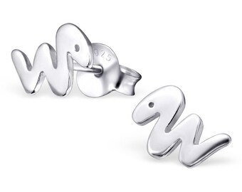 May include: A pair of silver earrings shaped like the letter 'W' with a small dot in the center of each earring. The earrings are made of sterling silver and have a 925 stamp on the back.