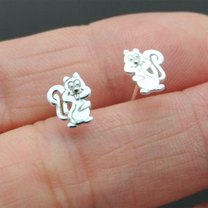 May include: A pair of silver stud earrings featuring a cute squirrel design.