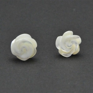 May include: A pair of white mother-of-pearl rose earrings. The roses are carved in a delicate swirl pattern.
