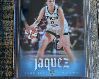 May include: A sports trading card featuring a basketball player in a white Chicago Sky jersey with the number 11, dribbling a basketball. The card displays the text RYAN FORS, jaquez, GABRIELA, and GUARD, enclosed in a clear protective plastic sleeve.
