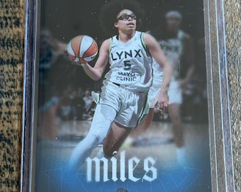 May include: A rectangular sports trading card featuring a basketball player in a white Lynx jersey with the number 5 and Mayo Clinic logo. The player holds a basketball. The card includes the text RYAN FORS, miles, OLIVIA, and GUARD.