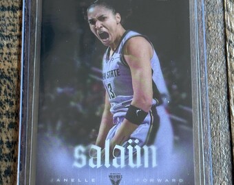 May include: A sports trading card featuring a basketball player in a white jersey with the number 13, shouting with intensity. The card displays the text RYAN FORS, SALAÜN, JANELLE, and VALKYRIES, encased in a clear protective plastic sleeve.