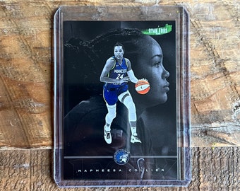 May include: A black and white basketball trading card featuring Napheesa Collier, a basketball player for the Minnesota Lynx. The card has a green and white signature at the top right corner that says "Ryan Fords".
