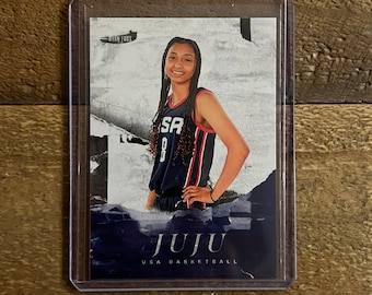 May include: A trading card featuring a basketball player wearing a USA basketball jersey with the name "Juju" printed on the front. The card has a blue and white background with a mountain scene.