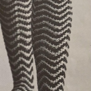 May include: A pair of black and white striped knee-high socks with a chevron pattern.