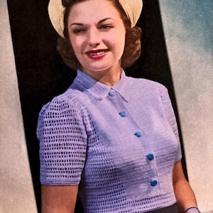 May include: A vintage photograph features a woman wearing a light purple, short-sleeved crochet top with blue buttons. She also wears a cream-colored head covering. The woman is smiling, and the background is a gradient of black and blue.