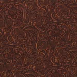 May include: A brown leather fabric with a repeating embossed pattern of floral designs. The pattern is a traditional western style.