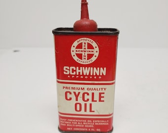 May include: A vintage Schwinn Cycle Oil can. The red metal can features the Schwinn logo and the words "Cycle Oil" in white. The can has a red spout and is labeled "Premium Quality". The can contains 4 fl oz.