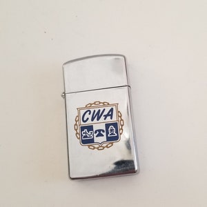 Vintage 1979 Zippo windproof slim cigarette lighter, good condition, crest for CWA Communication Workers America, sold as found has spark