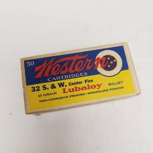 May include: A rectangular cardboard box for Western Cartridges containing 50 rounds of 32 S. & W. Center Fire Lubaloy bullets. The box features a blue top section with red text and a yellow bottom section with black text, including 85 grain specifications.