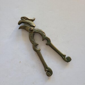 Vintage cast brass nutcracker, figural eagle couple different sizes of nuts, not marked anywhere. Deep patina