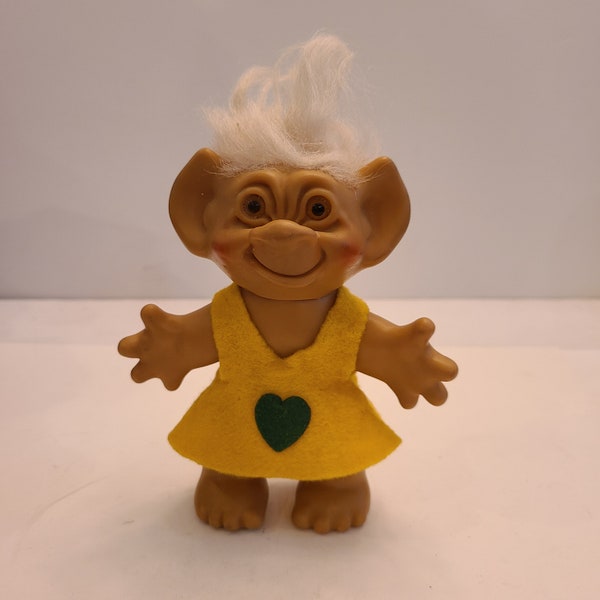 Vintage circa 1960's original troll doll by Uneeda Wishnik has felt dress with applied green heart.