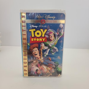 May include: A VHS tape of the Disney Pixar movie "Toy Story." The cover features Woody, Buzz Lightyear, and other characters against a blue background. The tape is labeled "Special Edition" and part of the "Walt Disney Classics" collection.