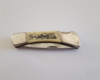 Vintage circa 1980's small pocket knife by Sabre Hong Kong, hunting scene with stags in forest, stainless steel, one scale side tad loose