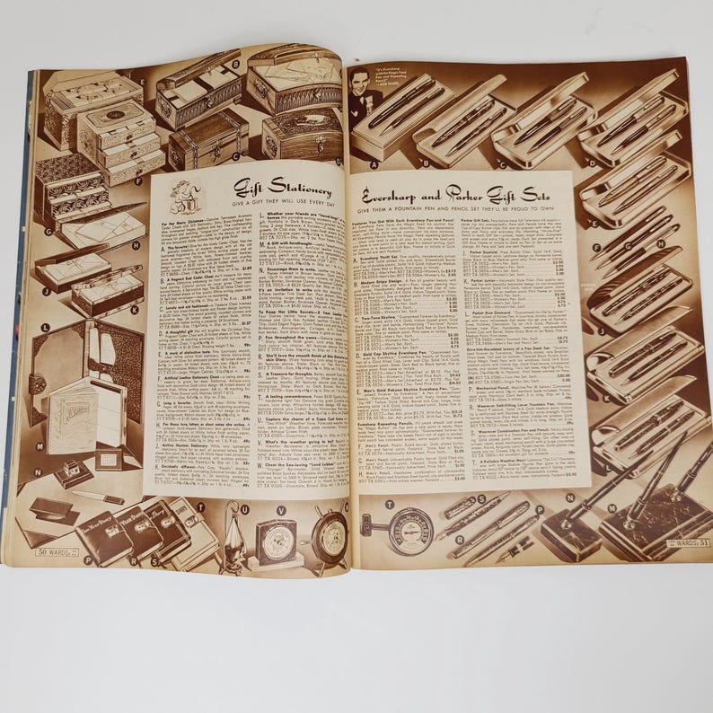 May include: A vintage magazine page featuring a selection of gift stationery and writing sets. The page includes a variety of items, such as leather-bound journals, pen and pencil sets, and desk accessories. The text on the page includes the title "Gift Stationery" and a list of items with their prices.