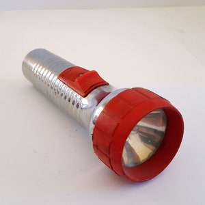 Vintage circa 1960&#39;s unmarked D cell flashlight with red safety head cap, working condition batteries not included