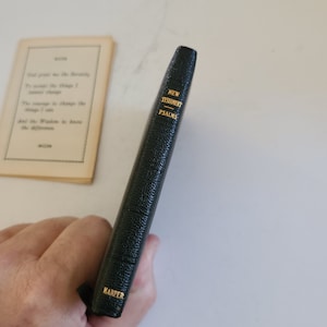 May include: A small, black, leather-bound book with gold lettering on the spine that reads "New Testament - Psalms" and "Harper" at the bottom.