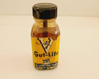 Vintage circa 1950's to 1960's Victor Sports bottle of "Gut-Life 9 lives for your tennis strings" it has dried residue and losses to label