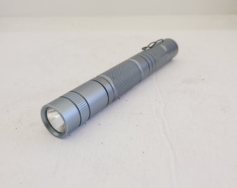 Vintage circa 2005 Romisen RC-I3 model LED 2 AA cell battery flashlight, nice blue machined aluminum, batteries included.