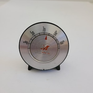 Vintage advertising cast metal desk thermometer unknown company logo United-Metro, Inc, works well.