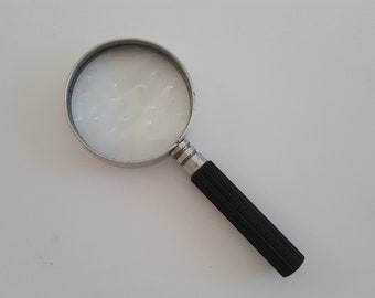 Vintage 1960's plastic handle magnifying glass, 2" thick glass, possible aluminum frame marked Japan.