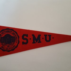 May include: Red felt pennant with a black circle containing the words "Southern Methodist University" and a building illustration. The words "S.M.U." are printed in black on the pennant.