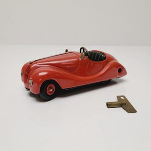 Vintage Schuco model Akustico 2002 wind up tin toy car made in US Zone Western Germany, brass key not original, works, missing windscreen.