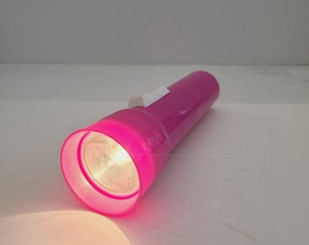 Vintage 1998 plastic 100th Anniversary Eveready working flashlight, takes 2 D cells that are not included, seldom seen pink color