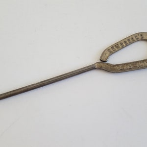 May include: A metal boot hook with a hook on one end and a loop on the other. The loop is inscribed with "LEWSEBECK'S EULERS PATENTED".