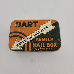 May include: Orange and black metal tin with the text "DART" in black letters, "REG. U. PAT. OFF." in smaller black letters, and "HANDY FOR ODD JOBS" in white letters on a white arrow. The text "FAMILY NAIL BOX" is in black letters on a black background, and "NET WEIGHT 7 OZ." is in smaller black letters below.