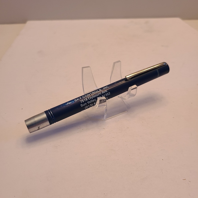 May include: A blue pen with silver accents and the text "SKY CONTROLS, INC. 7518 Clybourn Ave. Sun Valley, 91352 (213) 8703" printed on the side.