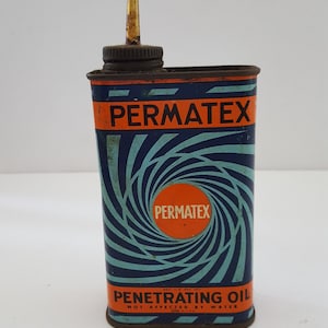 Vintage early 1960's Permatex Penetrating Oil  can with cool graphics and partial contents.