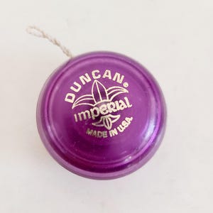 Vintage circa 1980's Genuine Duncan Imperial Yo-yo purple color with gold writing, used condition with some playwear, USA Made
