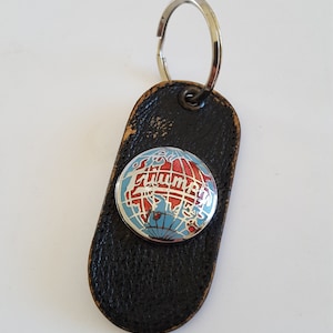 Vintage unknown decade Triumph Automobile logo enamel and leather keyring fob, Made in England of Moroccan leather