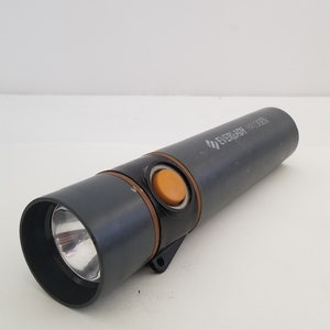 May include: A gray flashlight with an orange button and the text "EVEREADY  H400EN" printed on the side.