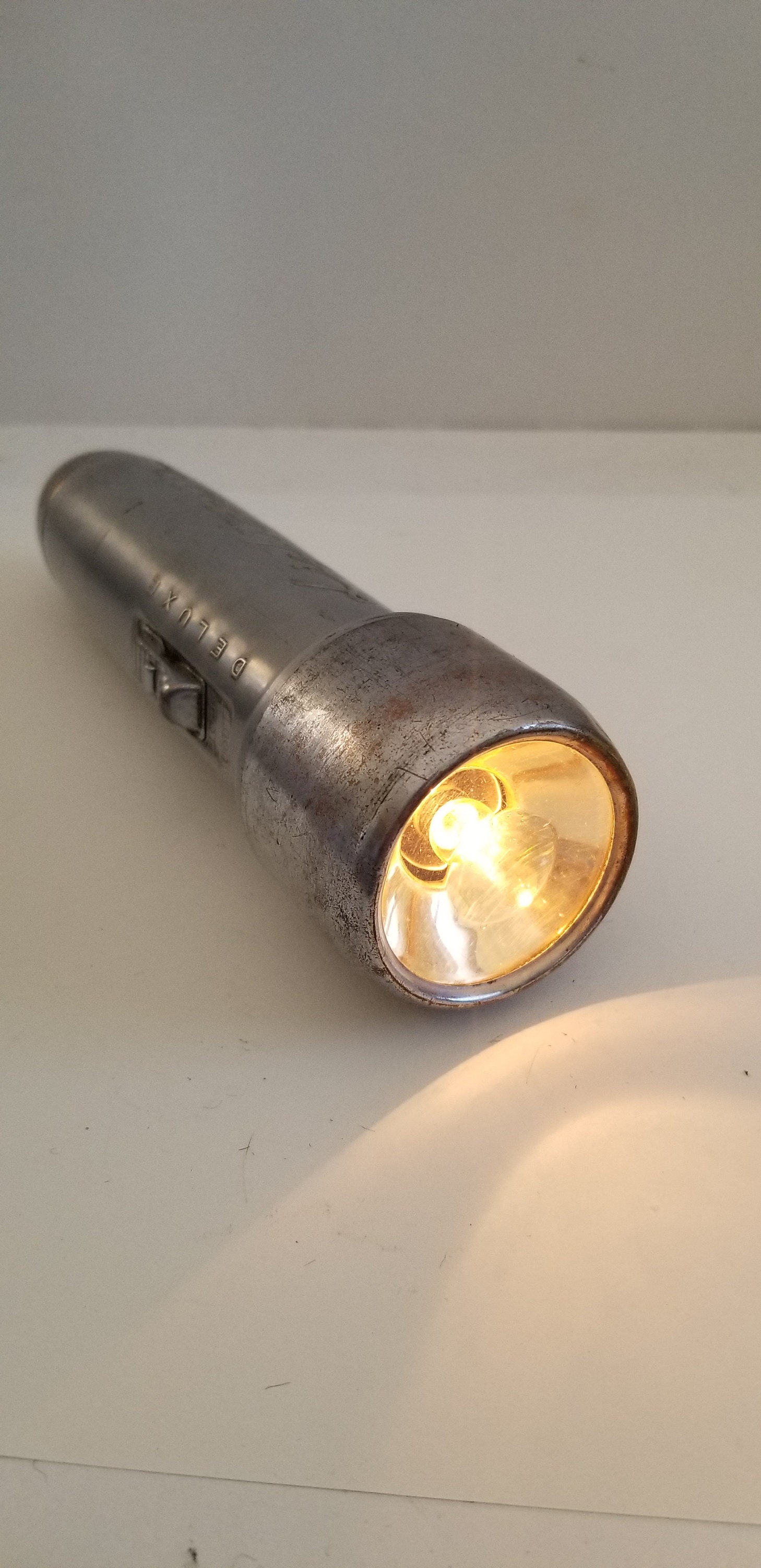Vintage circa 1945 post war Lightmaster Deluxe 2 D cell Art Deco design flashlight, spot and floodlight switch, worn but working condition