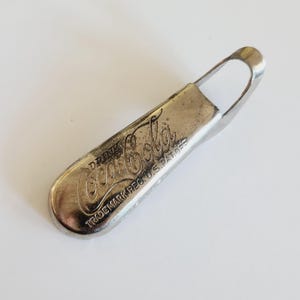 Vintage 1940&#39;s Coca Cola bottle opener &quot;Drink Coca Cola&quot;  cleaned condition with some plate loss, Consolidated Cork Corp. Brooklyn NY