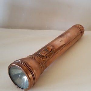 Vintage circa 1930&#39;s unmarked solid copper 3 D cell working flashlight great look batteries not included switch has patent date Dec 20 1921