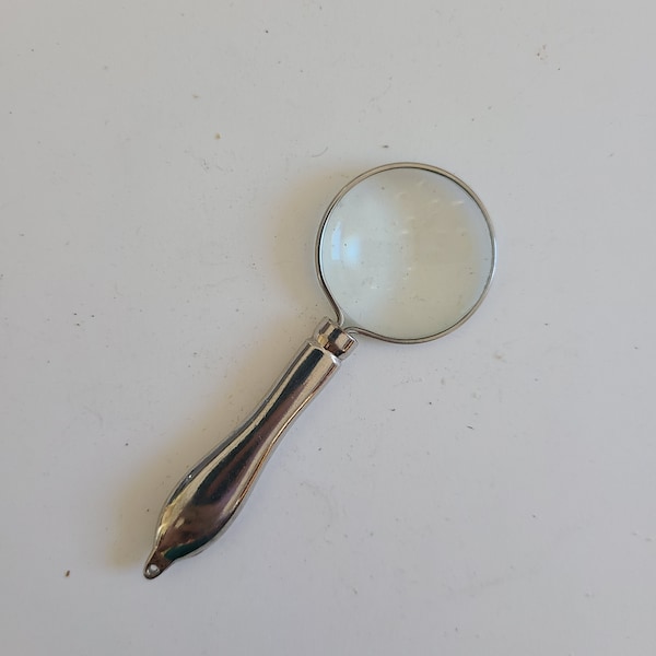 Vintage circa 1970's miniature magnifying glass unknown power designed for use with a chain, chrome plate 1 1/4" glass