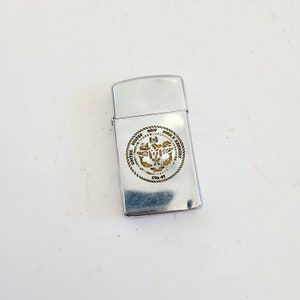 Vintage 1970 Zippo slim lighter USS John F. Kennedy CVA-67 &quot;Big John&quot;, used good condition has spark scratches and worn badge, loose hinge