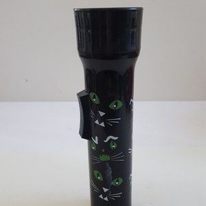 Vintage circa 1990&#39;s black cat plastic flashlight,  working condition but not marked accepts 2 D cell batteries not included